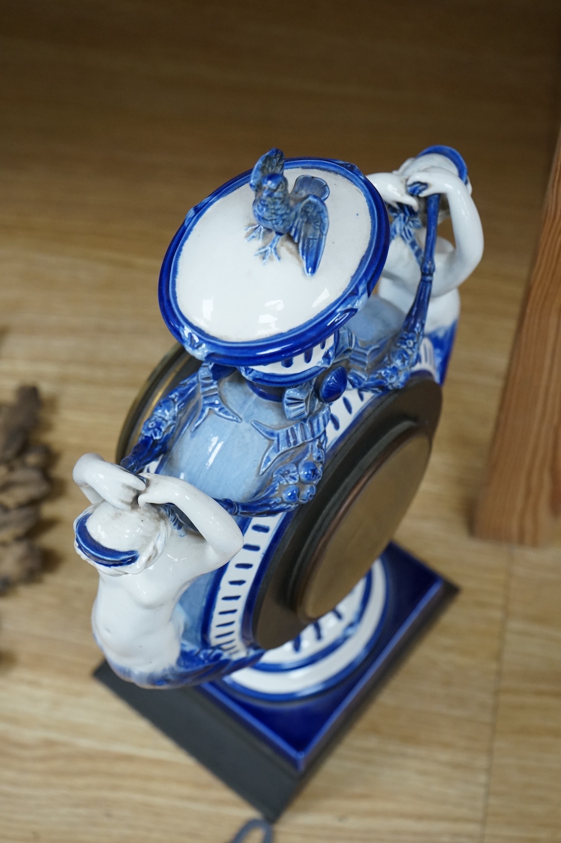 An early 20th century figural glazed ceramic mantle clock, 21cm wide x 40cm high
